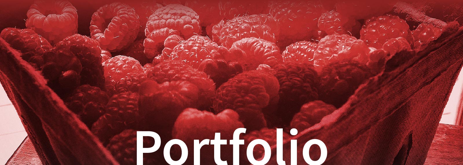 banner image for Portfolio page - close up of a basket of raspberries, all washed in a red hue.