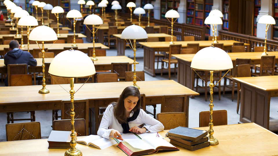 Portfolio Image: Stock photography of a couple students studying in a grand library space.