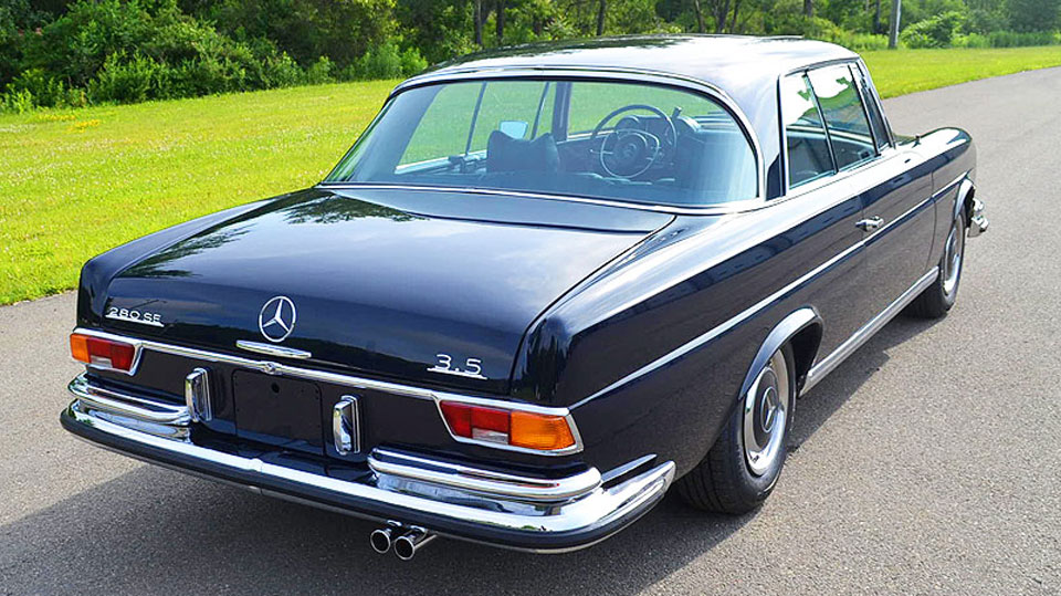Portfolio image: Photograph of a Star Motors vehicle for sale, angled rear view of a polished black Mercedes 280 SE 3.5.