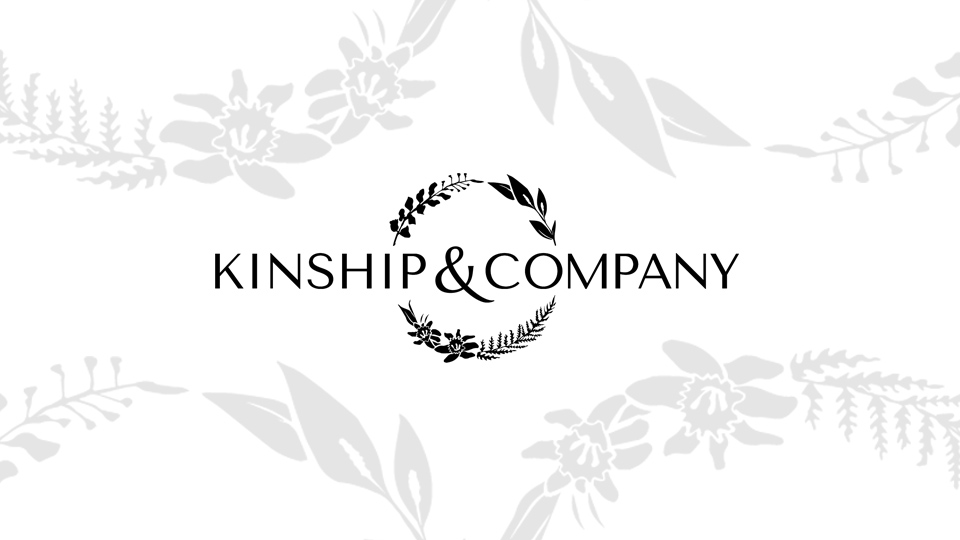 Kinship and Company Logo with elements of logo larger and semi-transparent in background, a design of illustrated plant and flower arches.
